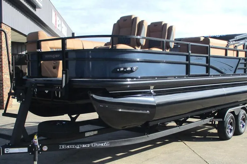 Slide: The Image of 2026 Ranger 220FC pontoon boat on trailer, featuring sleek design and comfortable seating. - 2