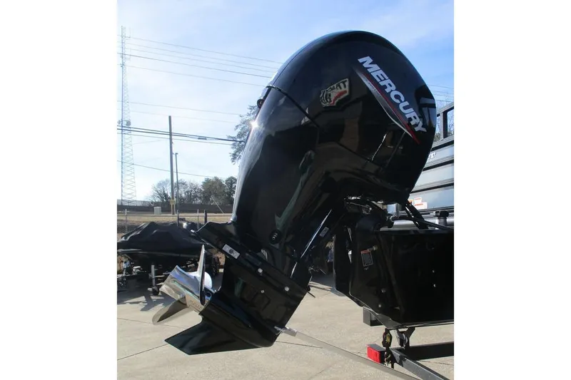 Slide: The Image of 2026 Ranger 220FC boat with Mercury outboard motor in a sunny outdoor setting. - 3