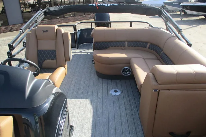 Slide: The Image of 2026 Ranger 220FC boat interior with tan seating and modern design. - 5