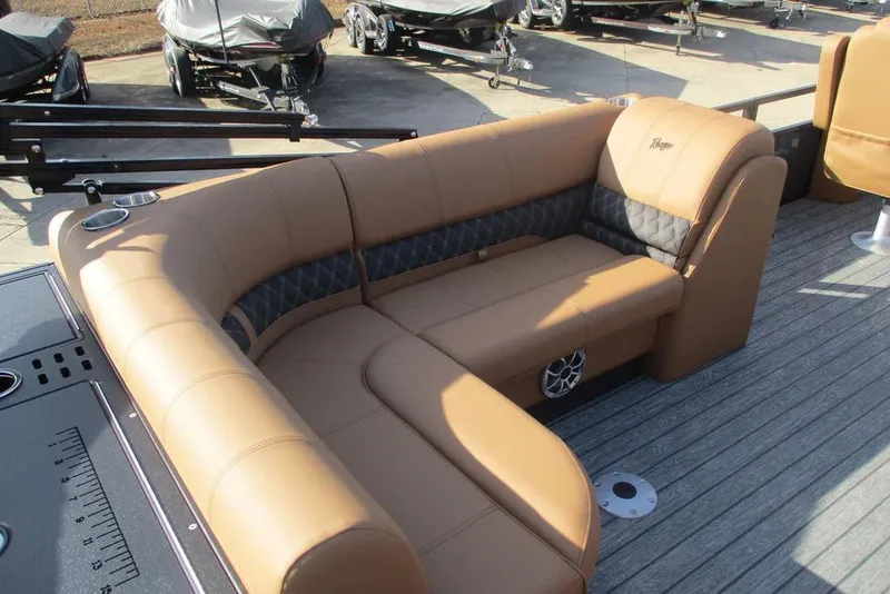 Slide: The Image of Luxurious seating on 2026 Ranger 220FC boat with tan upholstery and cup holders. - 6