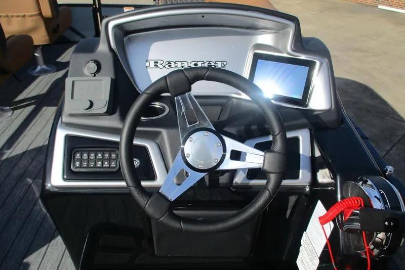 Slide: The Image of 2026 Ranger 220FC boat dashboard with steering wheel and digital display. - 8