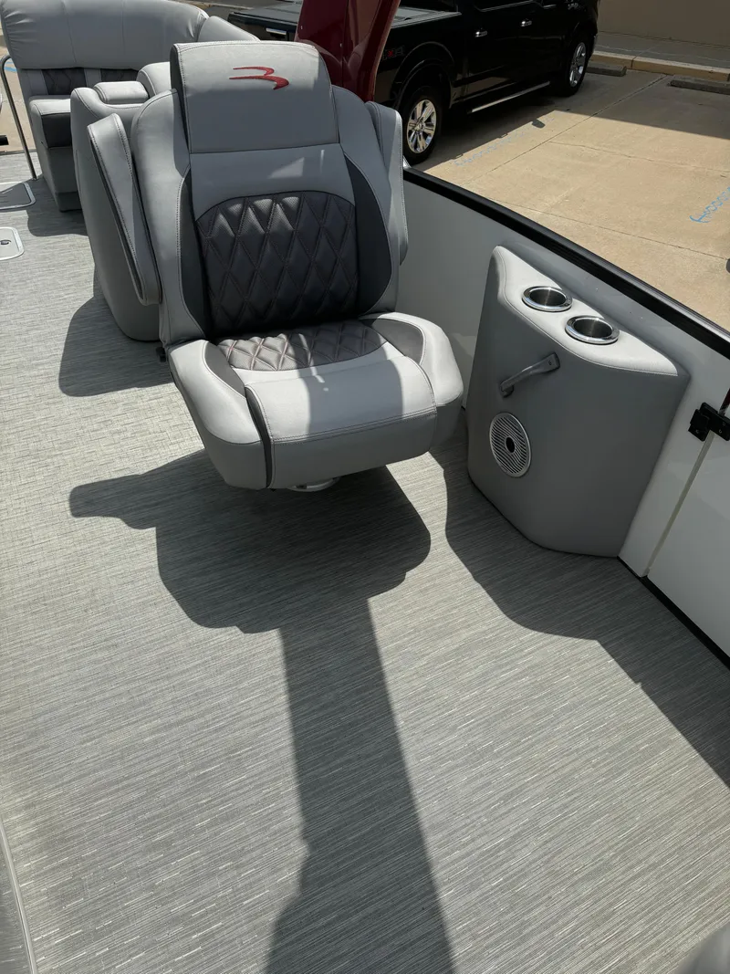 Slide: The Image of 2022 Bennington 28 QXFBA boat interior with luxurious seating and cup holders. - 13