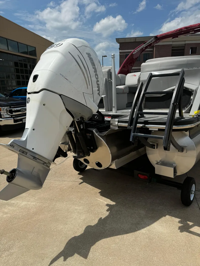 Slide: The Image of 2022 Bennington 28 QXFBA boat with outboard motor and ladder. - 17