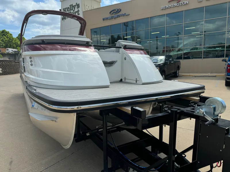 Slide: The Image of 2022 Bennington 28 QXFBA pontoon boat on trailer at dealership. - 2