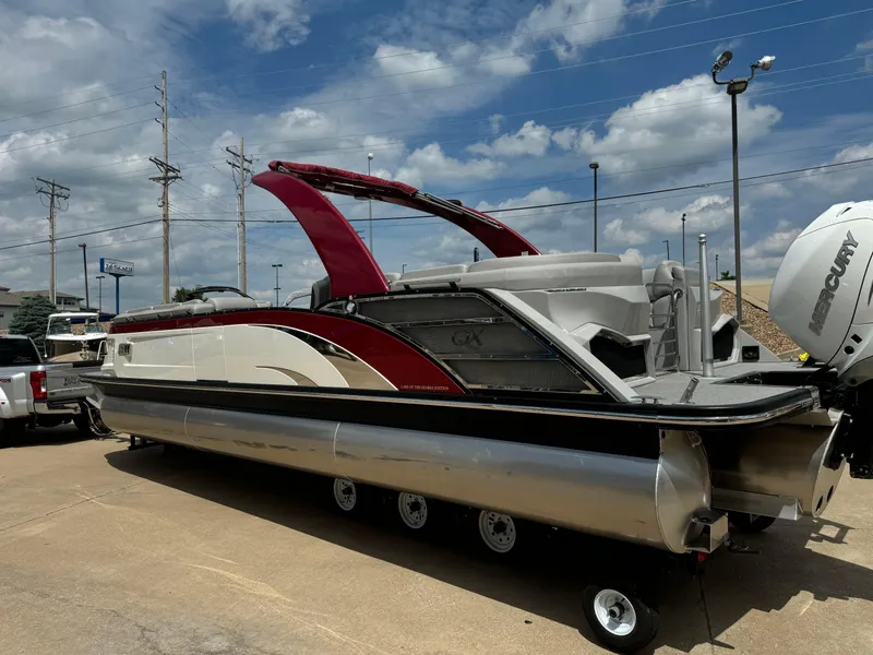 Slide: The Image of 2022 Bennington 28 QXFBA pontoon boat with red and white accents on a trailer. - 3