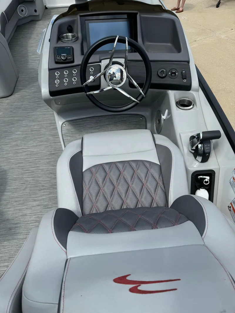 Slide: The Image of 2022 Bennington 28 QXFBA boat cockpit with modern steering wheel and control panel. - 8