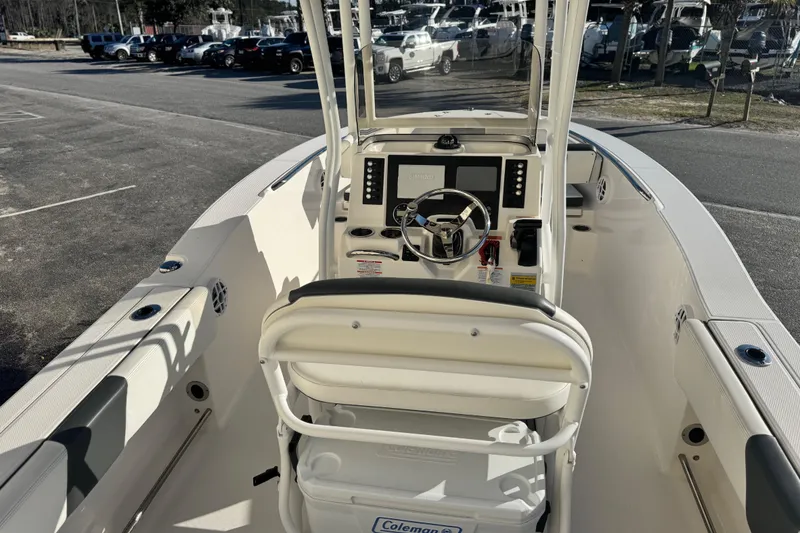 Slide: The Image of 2023 Robalo R202 Explorer boat interior with steering console and seating. - 2