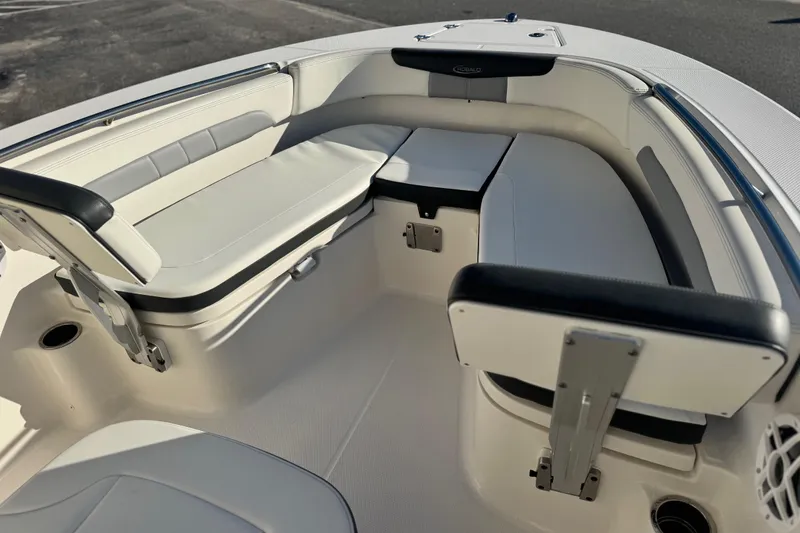 Slide: The Image of 2023 Robalo R202 Explorer boat interior with cushioned seating and storage compartments. - 3