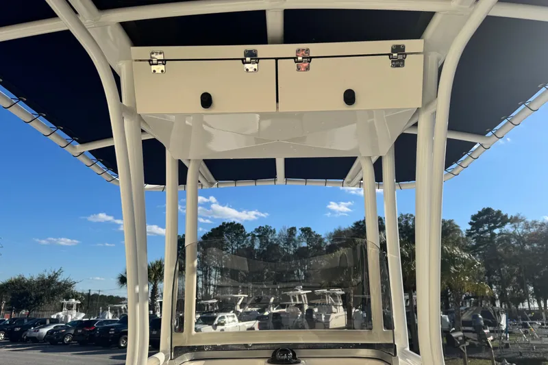 Slide: The Image of 2023 Robalo R202 Explorer boat with T-top and storage compartment, under clear blue sky. - 7