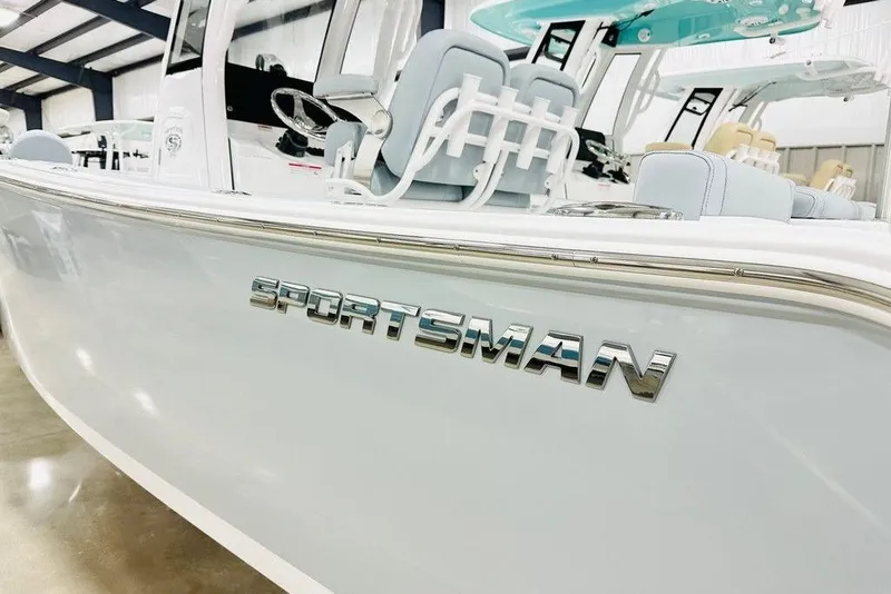 Slide: The Image of 2026 Sportsman Heritage 231 Center Console boat in showroom, featuring sleek design and modern seating. - 17