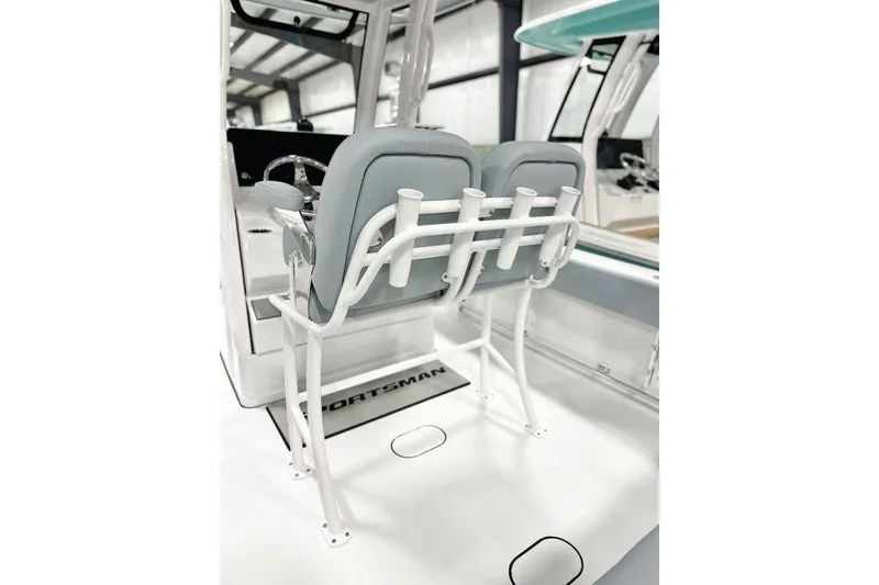 Slide: The Image of 2026 Sportsman Heritage 231 Center Console boat interior with dual seats and rod holders. - 6