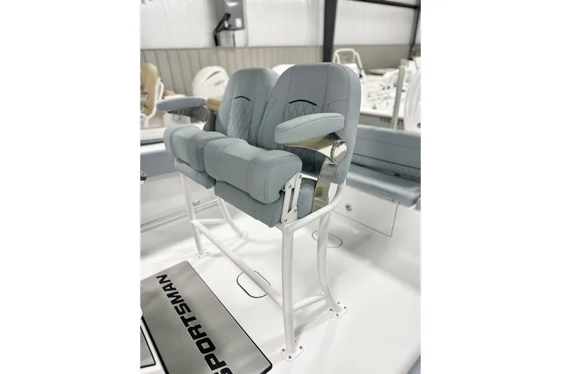 Slide: The Image of 2026 Sportsman Heritage 231 Center Console boat with dual cushioned seats and armrests. - 7