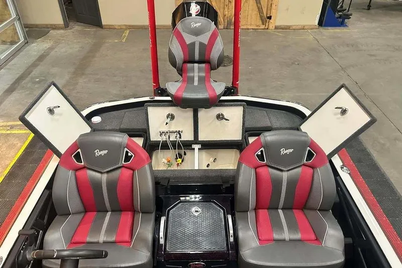 Slide: The Image of 2024 Ranger Z520R Cup-Equipped boat interior with red and gray seats, storage compartments open. - 9