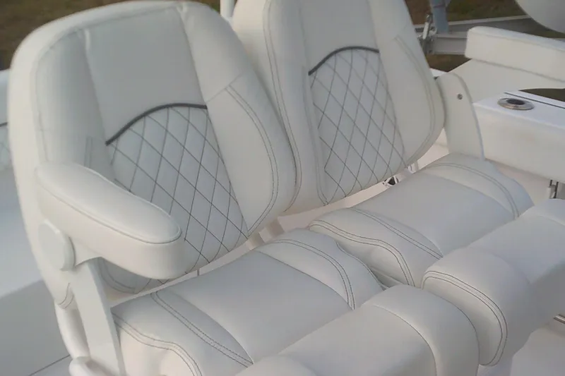 Slide: The Image of 2023 Sportsman Heritage 241 Center Console boat seats with diamond stitching. - 13