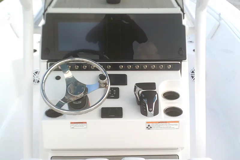 Slide: The Image of 2023 Sportsman Heritage 241 Center Console dashboard with steering wheel and controls. - 14