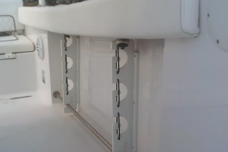 Slide: The Image of 2023 Sportsman Heritage 241 Center Console interior detail, featuring rod holders and seating. - 19