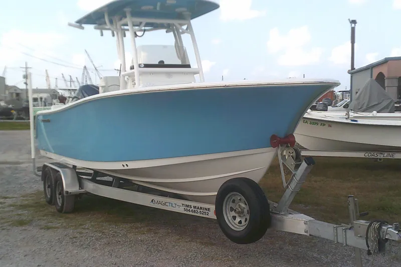 Slide: The Image of 2023 Sportsman Heritage 241 Center Console boat on trailer, blue hull, parked outdoors. - 3