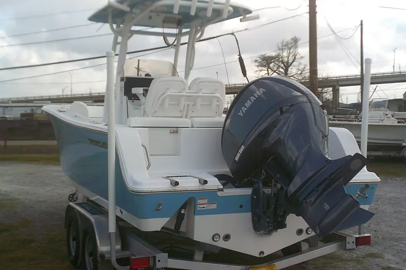 Slide: The Image of 2023 Sportsman Heritage 241 Center Console boat with Yamaha outboard motor on trailer. - 5