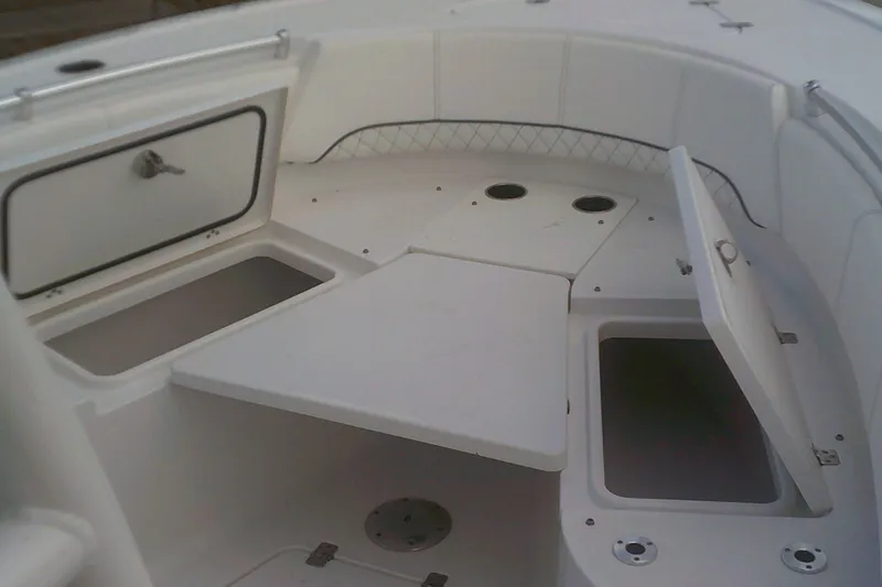 Slide: The Image of 2023 Sportsman Heritage 241 Center Console boat interior with storage compartments open. - 7