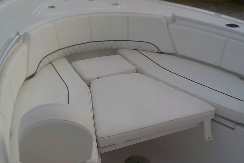 Slide: The Image of 2023 Sportsman Heritage 241 Center Console boat with cushioned seating area. - 8