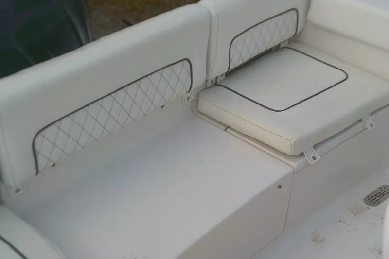 Slide: The Image of 2023 Sportsman Heritage 241 Center Console boat seating with white cushioned upholstery. - 9