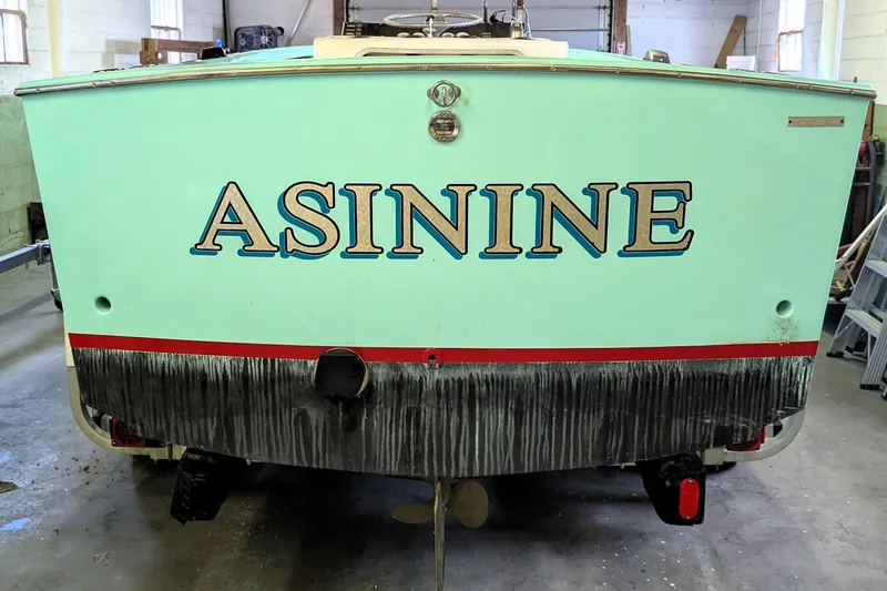 The Image of 1963 Rybovich 22 boat named "ASININE" in a workshop setting. - 0