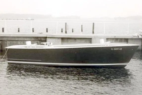 Slide: The Image of 1963 Rybovich 22 boat docked by the waterfront, showcasing classic design. - 15