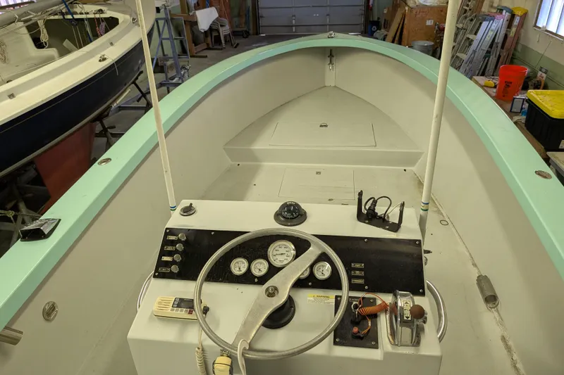 Slide: The Image of 1963 Rybovich 22 boat interior with vintage steering console in a workshop setting. - 2