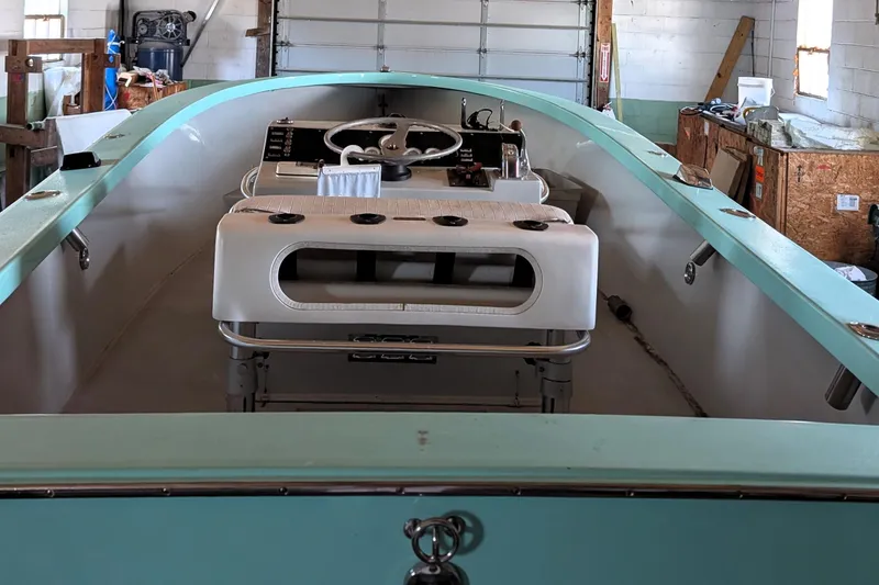 Slide: The Image of 1963 Rybovich 22 boat interior with vintage steering wheel and controls in a garage setting. - 3