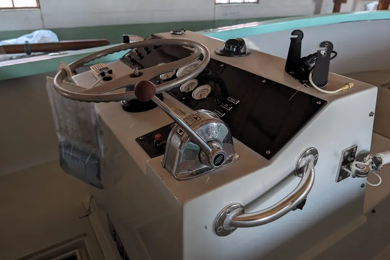 Slide: The Image of 1963 Rybovich 22 boat dashboard with steering wheel and control panel. - 4