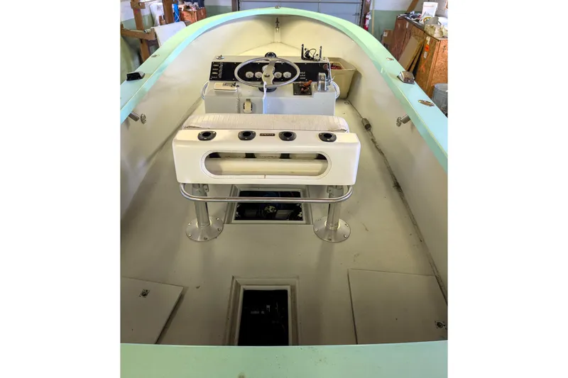 Slide: The Image of 1963 Rybovich 22 boat interior with steering console and seating. - 6