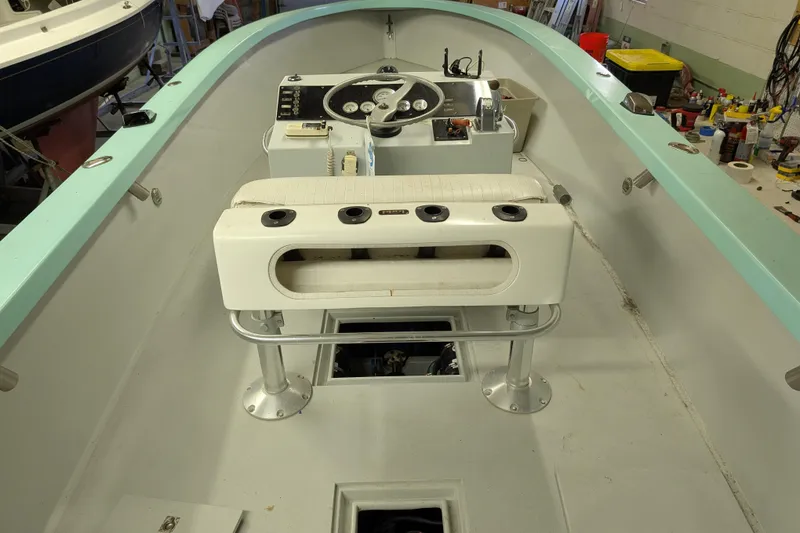 Slide: The Image of 1963 Rybovich 22 boat interior with steering console and seating. - 8
