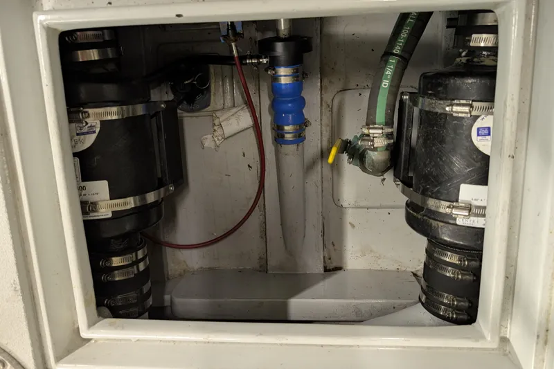 Slide: The Image of Engine compartment of a 1963 Rybovich 22 boat, featuring hoses and clamps. - 9