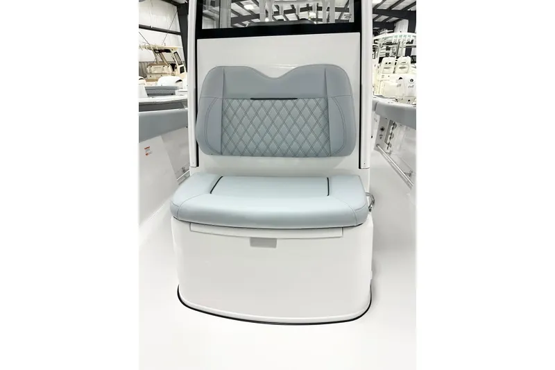 Slide: The Image of 2026 Sportsman Open 282 Center Console boat seat with quilted design and light blue upholstery. - 12