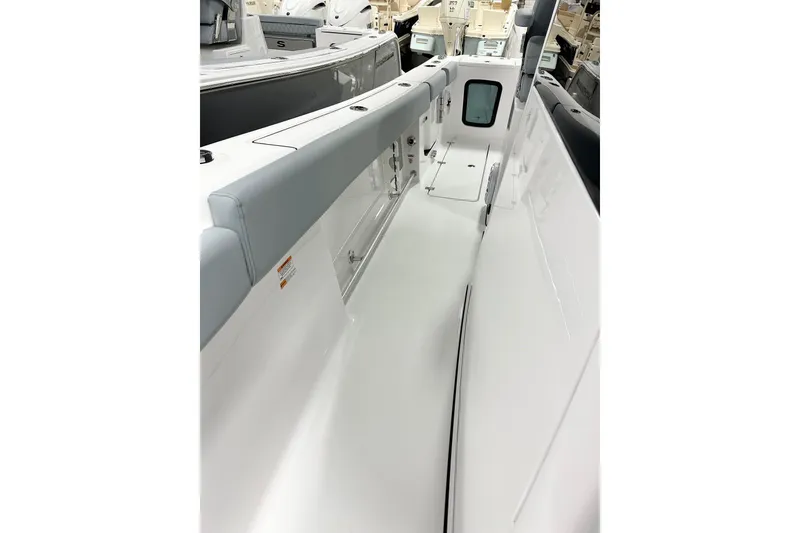 Slide: The Image of 2026 Sportsman Open 282 Center Console boat interior, showcasing sleek white deck and seating. - 14