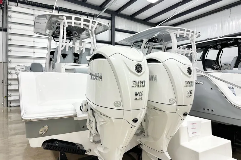 Slide: The Image of 2026 Sportsman Open 282 Center Console with twin Yamaha 300 V6 engines in showroom. - 18