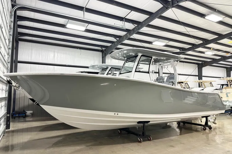 The Image of 2026 Sportsman Open 282 Center Console boat in a showroom, side view. - 2