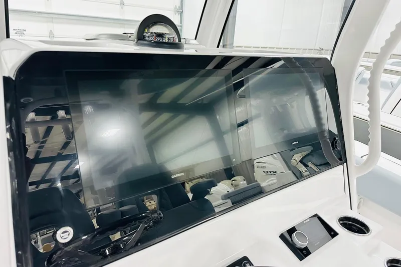 Slide: The Image of 2026 Sportsman Open 282 Center Console dashboard with Garmin display and steering wheel. - 4