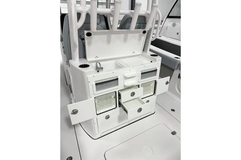 Slide: The Image of 2026 Sportsman Open 282 Center Console with open storage compartments and fishing rod holders. - 7