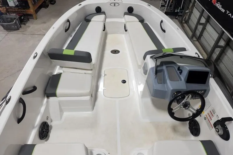 Slide: The Image of 2023 Tahoe T18 boat interior with seating and steering console in a showroom. - 4