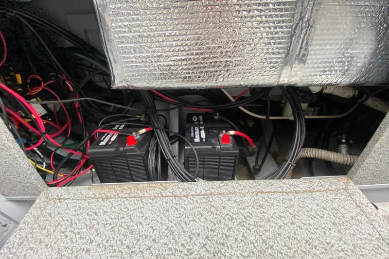 Slide: The Image of 2021 Hewescraft 210 Sea Runner ET Hardtop battery compartment with wiring and insulation. - 12