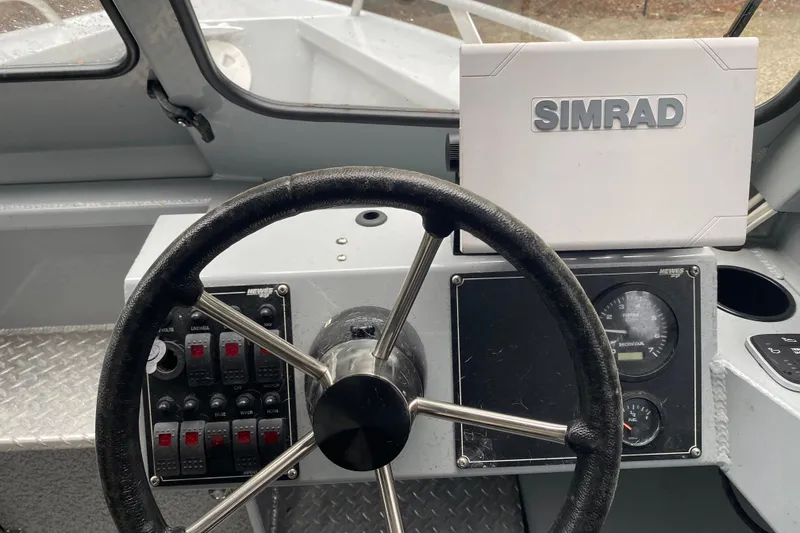 Slide: The Image of 2021 Hewescraft 210 Sea Runner ET Hardtop dashboard with steering wheel and Simrad display. - 13