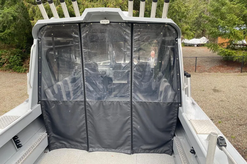 Slide: The Image of 2021 Hewescraft 210 Sea Runner ET Hardtop with protective cover, docked outdoors. - 6