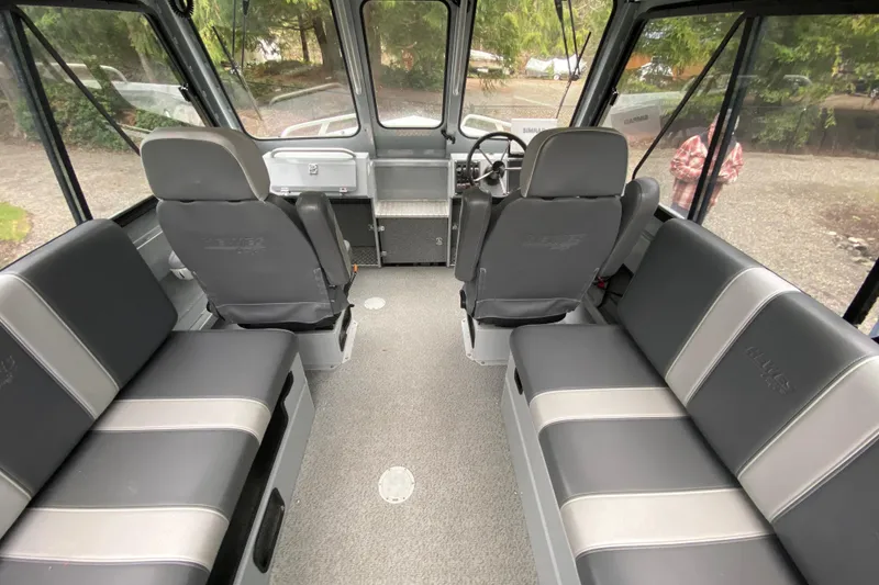 Slide: The Image of 2021 Hewescraft 210 Sea Runner ET Hardtop interior with seating and steering wheel. - 7