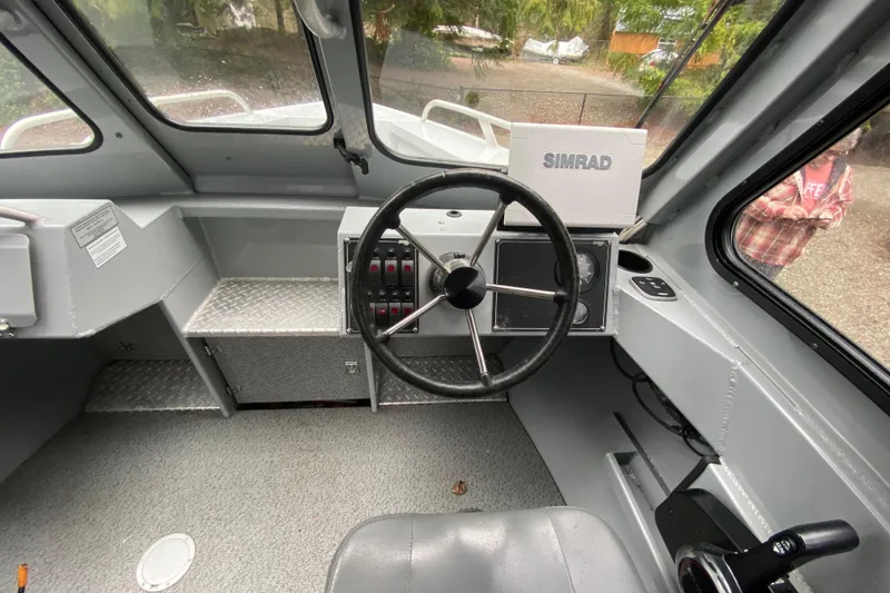 Slide: The Image of 2021 Hewescraft 210 Sea Runner ET Hardtop interior with steering wheel and Simrad display. - 8