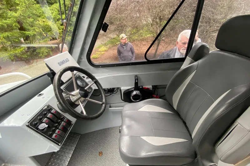 Slide: The Image of 2021 Hewescraft 210 Sea Runner ET Hardtop interior with steering wheel and control panel. - 9