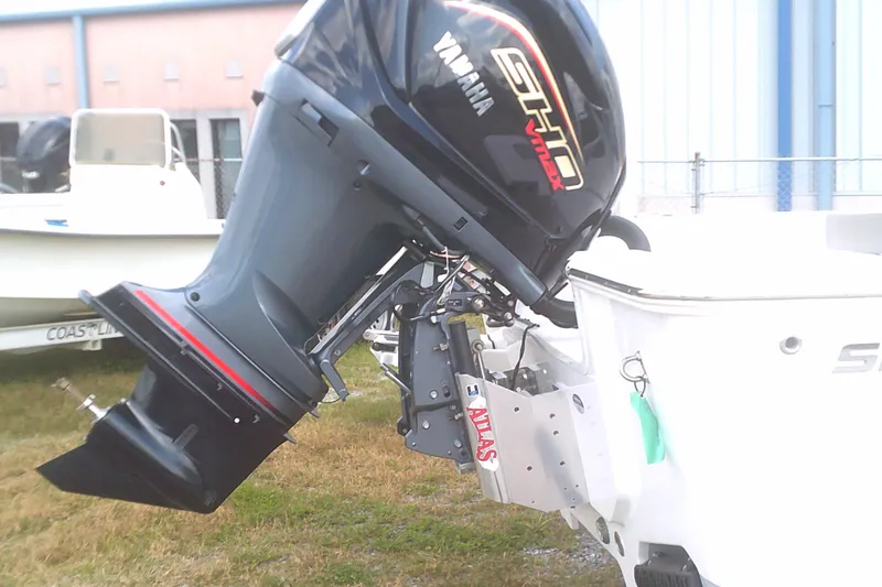 Slide: The Image of 2025 Sportsman Masters 227 Bay Boat with Yamaha outboard motor, parked outdoors. - 2