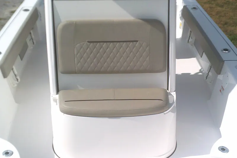 Slide: The Image of 2025 Sportsman Masters 227 Bay Boat interior seating with beige cushions. - 15