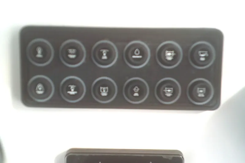 Slide: The Image of Control panel of 2025 Sportsman Masters 227 Bay Boat with various function buttons. - 21