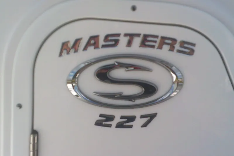 Slide: The Image of 2025 Sportsman Masters 227 Bay Boat logo on white surface. - 22